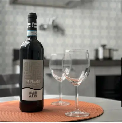 a bottle of wine and two wine glasses on a table at K-Vatican Apartment in Rome