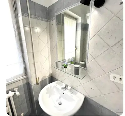 a bathroom with a sink and a mirror at K-Vatican Apartment in Rome