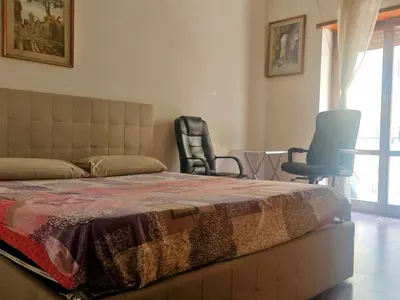 a bedroom with a bed and two chairs and a table at 5 metro stop colosseum in Rome