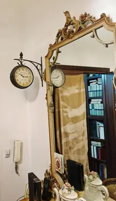 a mirror with two clocks on top of a table at 5 metro stop colosseum in Rome