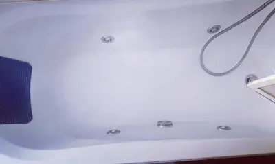 a bath tub with a shower head and a hose at 5 metro stop colosseum in Rome