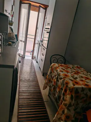 a bedroom with a bed and a kitchen with a window at 5 metro stop colosseum in Rome