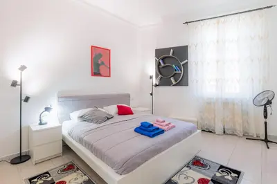 a bedroom with a bed with pink shoes on it at 10 Min Colosseum, PreNestInHome - Renovated 2024 Apartment, P igneto , Self Check-in h24 in Rome