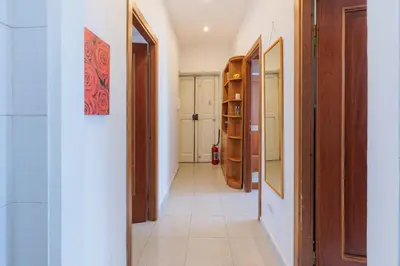 a hallway with wooden doors and a tile floor at 10 Min Colosseum, PreNestInHome - Renovated 2024 Apartment, P igneto , Self Check-in h24 in Rome