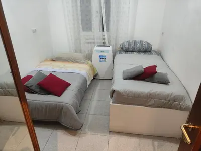 two beds sitting next to each other in a room at 10 Min Colosseum, PreNestInHome - Renovated 2024 Apartment, P igneto , Self Check-in h24 in Rome