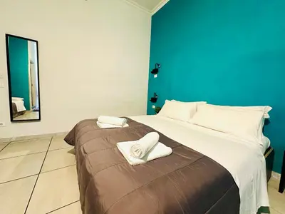 a bedroom with a large bed with two towels on it at Jupiter Home in Rome