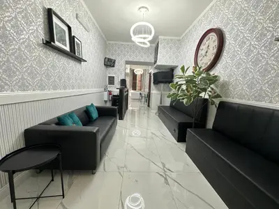 a living room with couches and a clock on the wall at Jupiter Home in Rome
