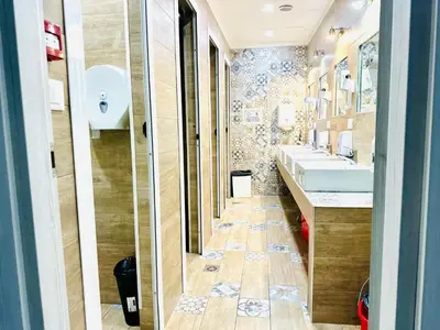 a bathroom with two sinks and two mirrors at Jupiter Home in Rome