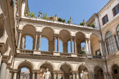 a building with statues on top of it at Casa Paolina, Burghesius homes in Rome