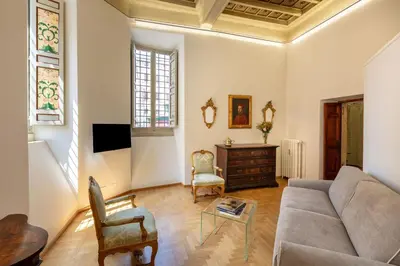 a living room with a couch and a table at Casa Paolina, Burghesius homes in Rome
