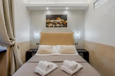 a bedroom with a bed with two white pillows at Vatican Sweet Dreams Apartment in Rome