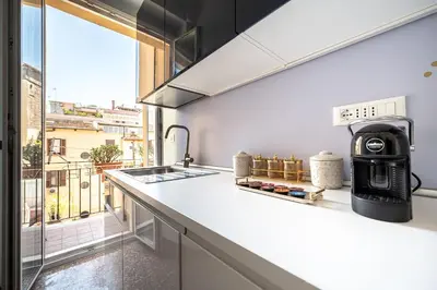 a kitchen with a counter and a large window at Exclusive View Rome I Residenza di Prestigio I 5 min metro Colosseo in Rome