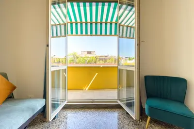 a mirror in a room with a chair and a window at Exclusive View Rome I Residenza di Prestigio I 5 min metro Colosseo in Rome