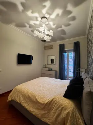 a bedroom with a bed and a chandelier at La casa di Gió in Rome