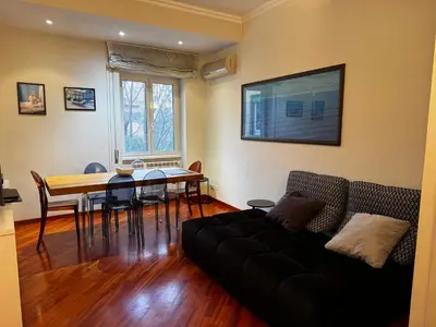 a living room with a couch and a dining room table at La casa di Gió in Rome