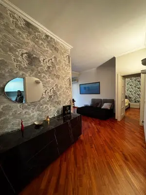 a living room with a couch and a mirror at La casa di Gió in Rome