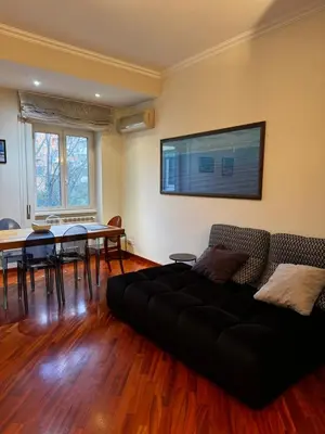 a living room with a black couch and a table at La casa di Gió in Rome