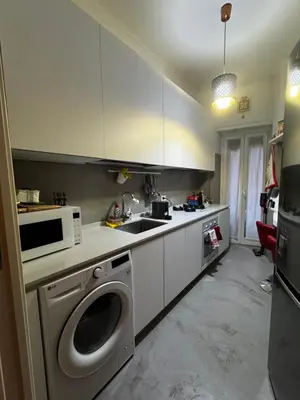 a kitchen with a washing machine and a microwave at La casa di Gió in Rome