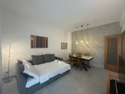 a bedroom with a bed and a dining room with a table at Urban Oasis with Garden in Rome