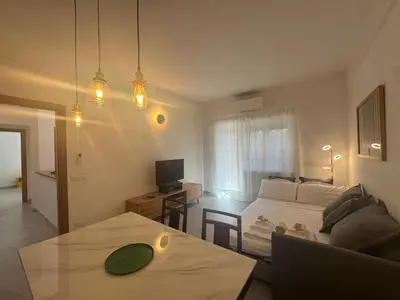 a bedroom with a bed and a table and a television at Urban Oasis with Garden in Rome
