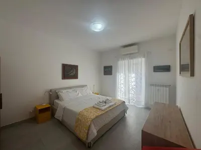 a bedroom with a bed and a table in it at Urban Oasis with Garden in Rome