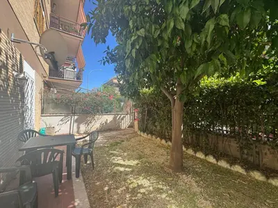 a table and chairs and a tree in a yard at Urban Oasis with Garden in Rome