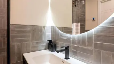 a bathroom with a sink and a mirror at Soggiorno Chic , 2 Camere Vicino Colosseo e Metro in Rome