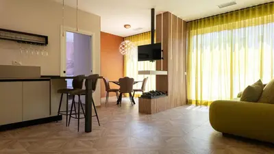 a kitchen and living room with a couch and a table at Soggiorno Chic , 2 Camere Vicino Colosseo e Metro in Rome