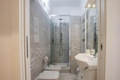 a bathroom with a shower and a toilet and a sink at VI Domus - Vatican Museum Guest House - Roma in Rome