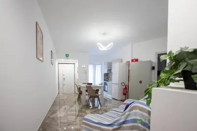 a kitchen and dining room with a table and refrigerator at VI Domus - Vatican Museum Guest House - Roma in Rome