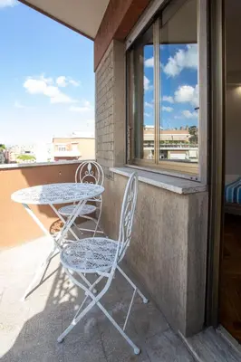 a table and two chairs sitting on a balcony at VI Domus - Vatican Museum Guest House - Roma in Rome