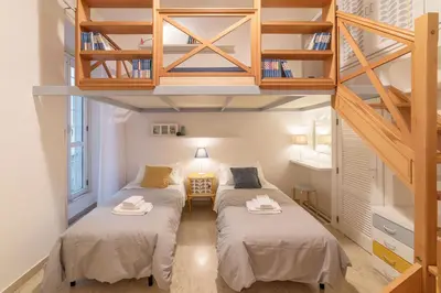 two beds in a small room with stairs at Casa Aurora - WelcomeToRhome in Rome