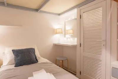 a bedroom with a bed with a mirror and a sink at Casa Aurora - WelcomeToRhome in Rome