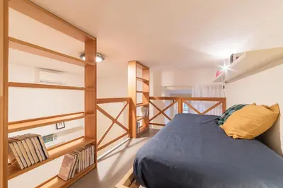 a small bedroom with a bed and bunk beds at Casa Aurora - WelcomeToRhome in Rome