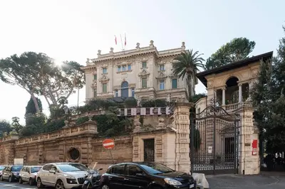 a building with cars parked in front of it at Casa Aurora - WelcomeToRhome in Rome