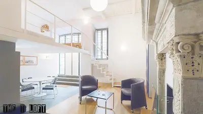 a room with a table and chairs and a staircase at Trastevere Loft in Rome