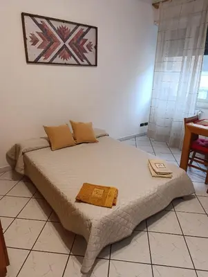 a bed in a room with two towels on it at San Giovanni Apartment in Rome