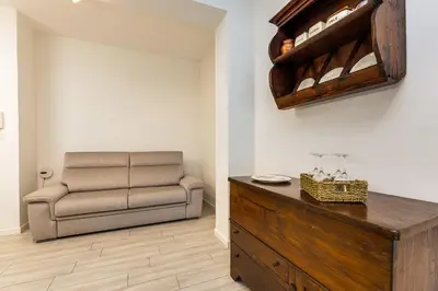 a living room with a couch and a chair at Pica's House in Rome