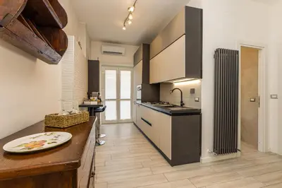 a kitchen with a counter with a sink and a stove at Pica's House in Rome