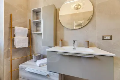 a bathroom with a white sink and a mirror at Pica's House in Rome