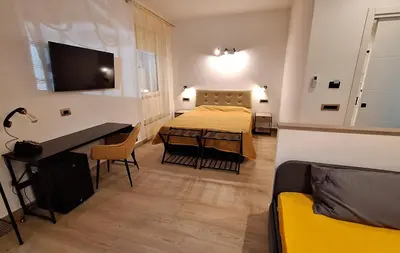 a bedroom with a bed and a desk in a room at Domus Albalonga in Rome