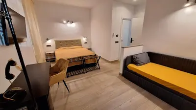 a small room with two beds and a table at Domus Albalonga in Rome