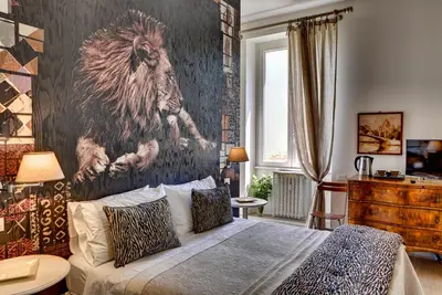 a bedroom with a bed with a lion on the wall at Casa Sotgiu Guest House in Rome