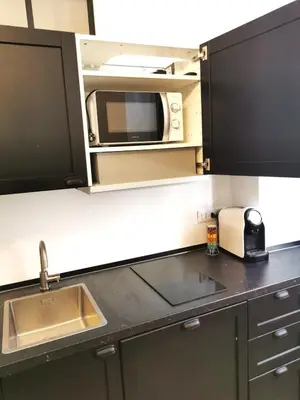 a kitchen with a sink and a microwave at Casa D'Agata in Rome