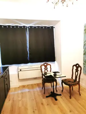 a kitchen with two chairs and a table in front of a window at Casa D'Agata in Rome
