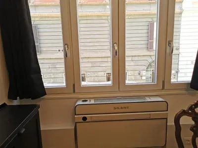 a kitchen with three windows and a dishwasher at Casa D'Agata in Rome