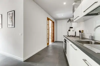 a kitchen with white cabinets and a sink at FaMa - Quiet&Bright 2BR Apartment in Rome