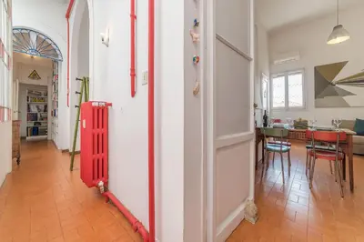 a hallway with a red door and a dining room at Casa di Cosimo - WelcomeToRhome in Rome
