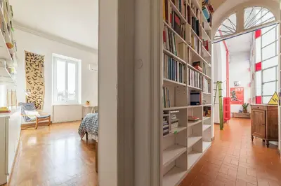 a room with a book shelf filled with books at Casa di Cosimo - WelcomeToRhome in Rome