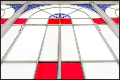 a red and white window in a church at Casa di Cosimo - WelcomeToRhome in Rome
